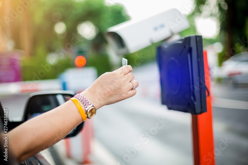 woman stop car and use key card to open the door for safety. photo