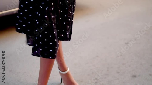 Beautiful woman legs wearing while heels. Closeup photo