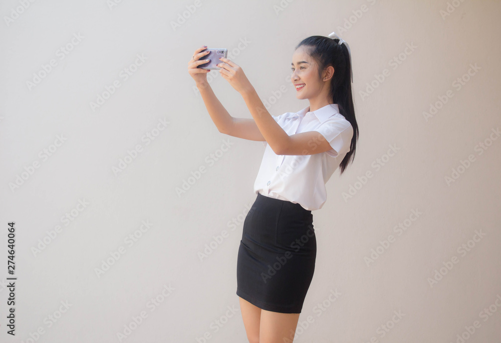 Portrait of thai adult student university uniform beautiful girl using her smart phone Selfie Portrait of thai adult student university uniform beautiful girl using her smart phone Selfie