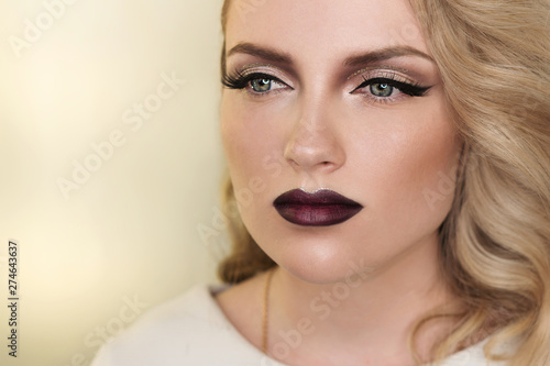 Close up portrait of attractive girl blondes. Perfect Skin. Long eyelashes. Dark lips. Trendy color lip. Beauty industry. Space for text 