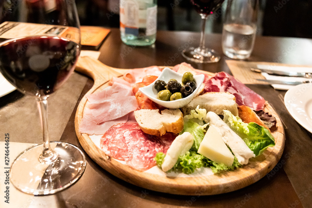 Serving of various types of iberico cold meats, cheese, olive