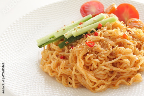 Asian food, mixed ramen noodles served with cucumber  photo