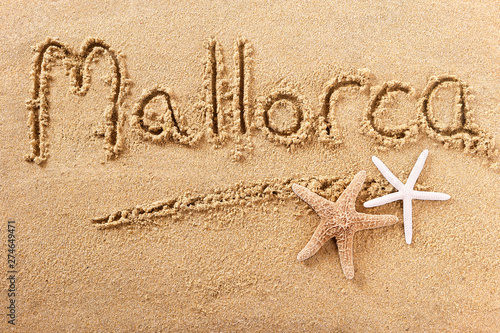 Mallorca majorca word written in sand on a sunny spanish summer beach with starfish holiday vacation travel destination sign writing message photo photo