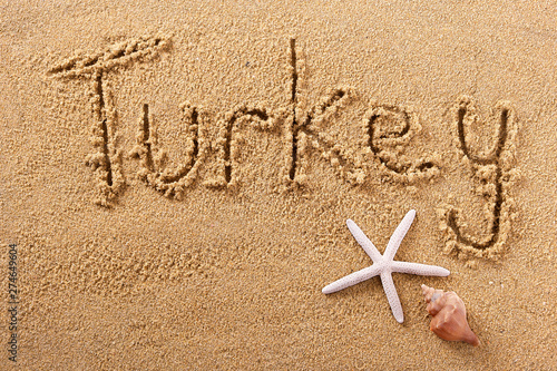 Turkey word written in sand on a sunny turkish summer beach with starfish holiday vacation travel destination sign writing message photo