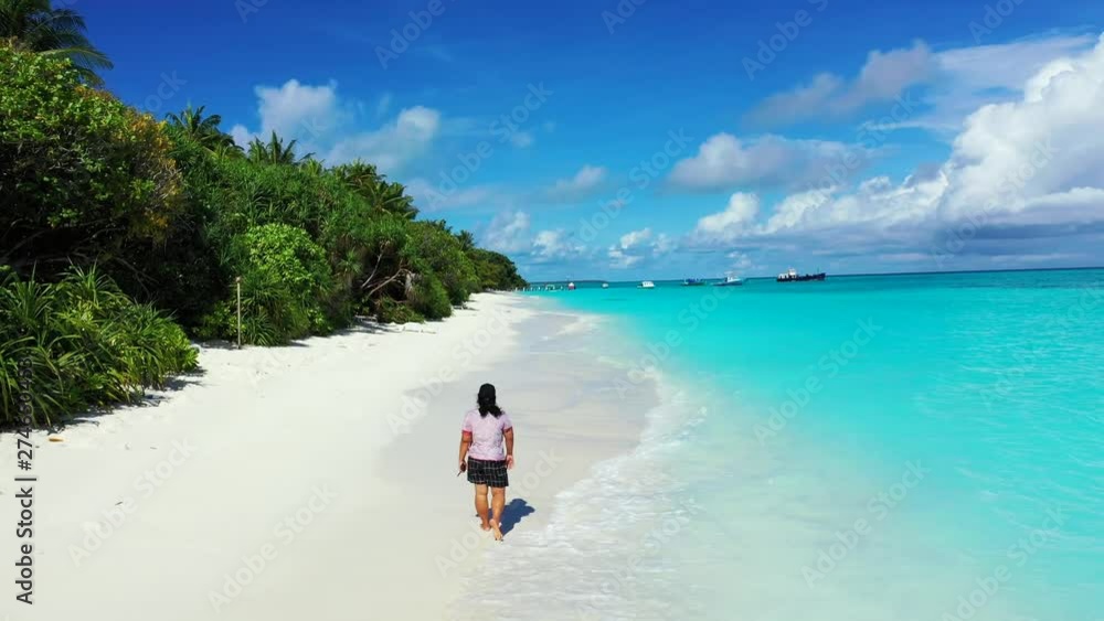 Young Woman Walking On A Sandy Beach Philippines - feet therapy on holiday concept , drone dolly in long shot Young Woman Walking On A Sandy Beach Philippines - feet therapy on holiday concept , drone dolly in long shot