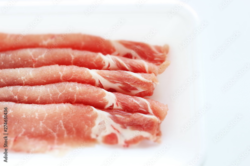 Sliced pork on food container for cooking image Sliced pork on food container for cooking image