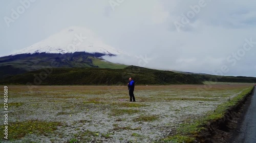 A man looking at the Cotopaxi Volcano from the Limpiopungo Lagoon, Cotopaxi Province Ecuador
