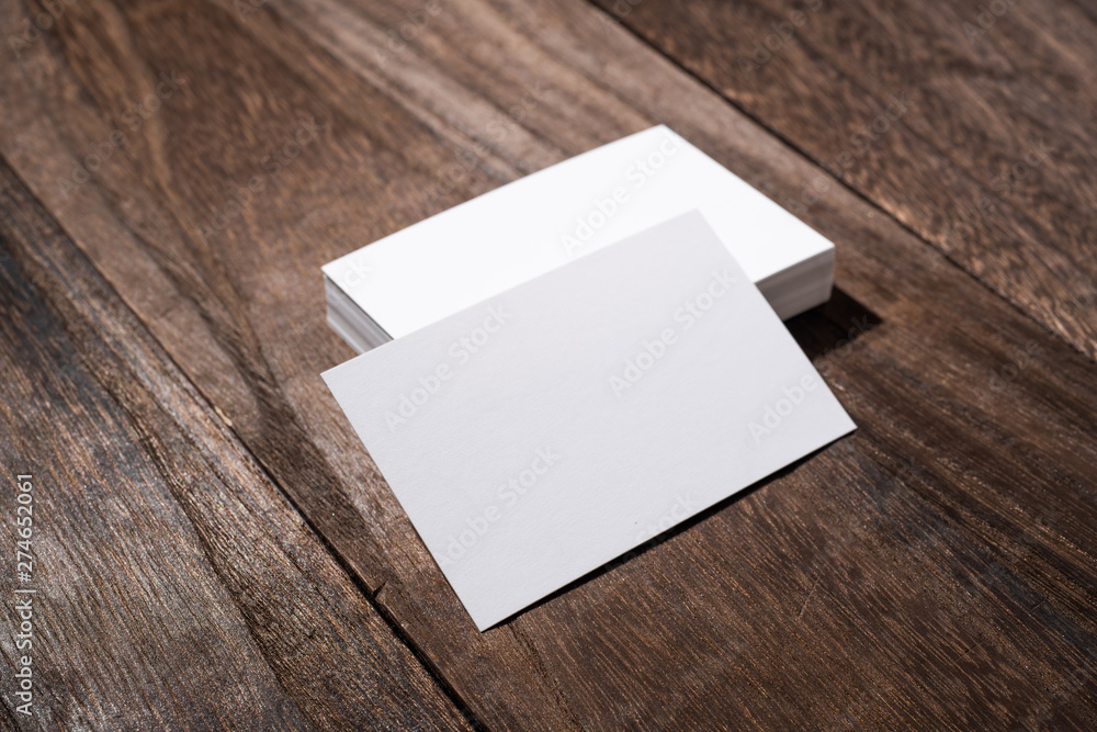 perspective view of white business card on wood floor perspective view of white business card on wood floor