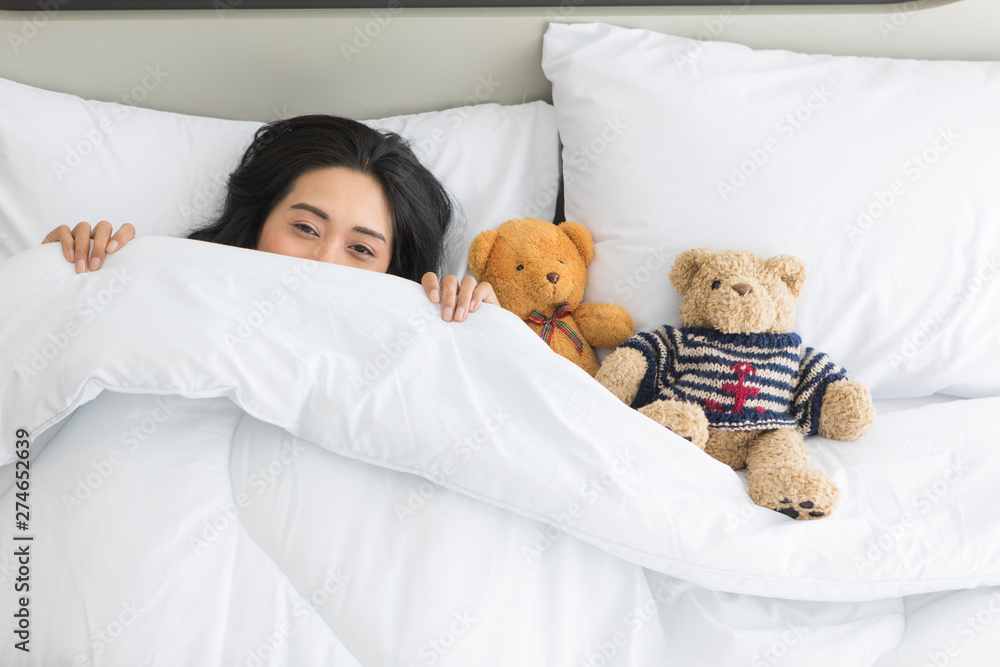Asian woman sleeps on bed with two teddy bear.. Asian woman sleeps on bed with two teddy bear..