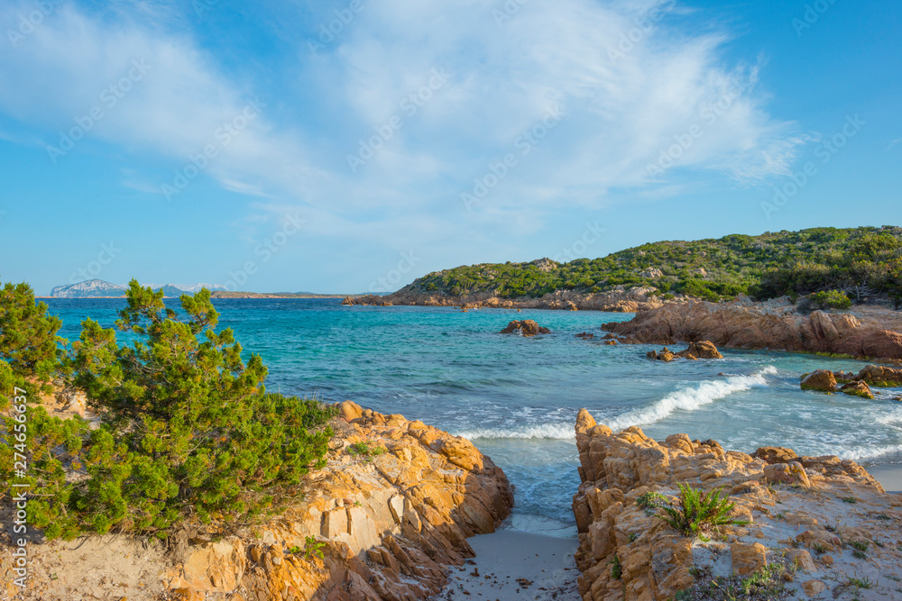 Rocky coast of the island of Sardinia in the Mediterranean Sea in sunlight in spring