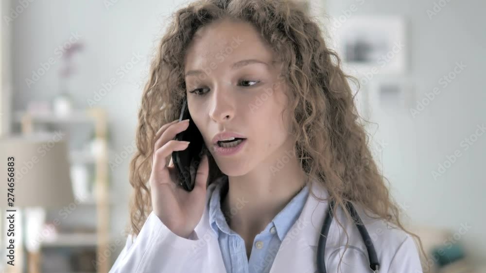 Young Lady Doctor Talking with Patient on Phone Young Lady Doctor Talking with Patient on Phone
