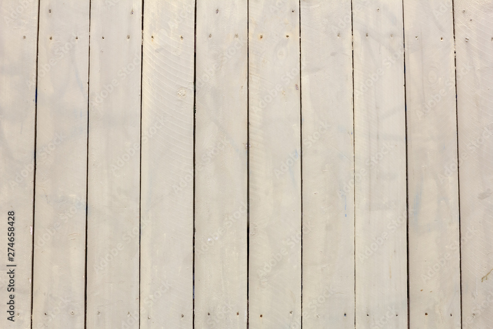 A beige colored wood panel background A beige colored wood panel background