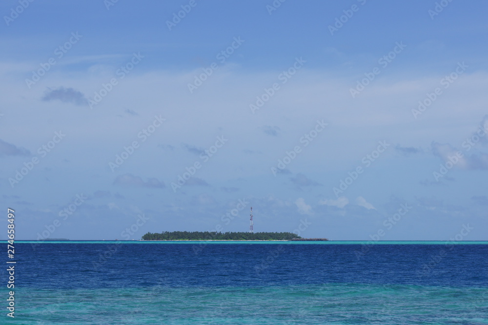 Tropical island in the middle of the ocean on a cloudy day