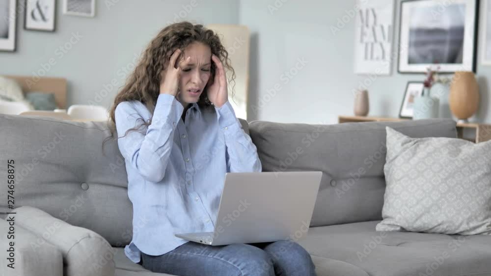 Frustrated Curly Hair Woman Reacting to Loss on Laptop while Sitting on Couch Frustrated Curly Hair Woman Reacting to Loss on Laptop while Sitting on Couch
