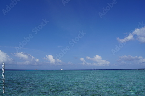 Beautiful sky and turquoise water of the Indian Ocean on a clear day. Maldives