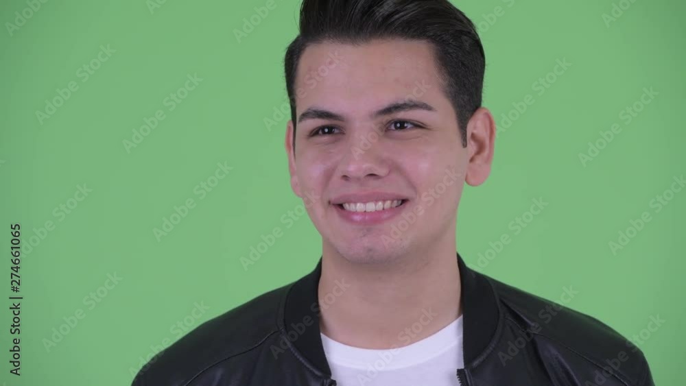 Face of happy young multi ethnic man with leather jacket thinking Face of happy young multi ethnic man with leather jacket thinking