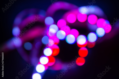 Purple Neon bokeh lights on black. Abstract blurred background photo