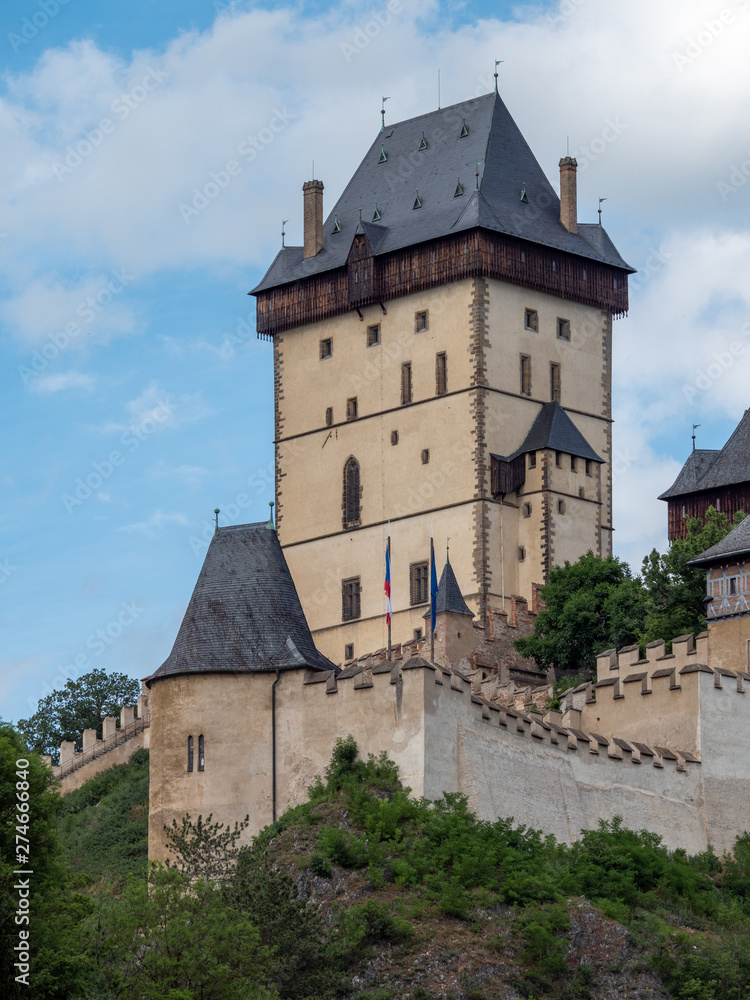 The Big Tower of Gothic Karlstejn Castle in Bohemia Czech Republic, a Medieval Fortress buildt by Holy Roman Emperor and Czech King Charles IV in Central Europe on a Sunny Summer Day.