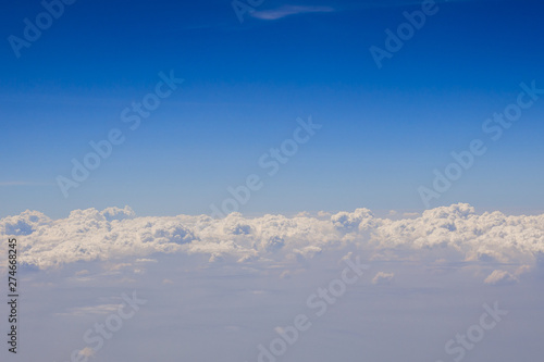 Topveiw from airplane window, Blue sky and clouds are combining white and waves. Copy space.