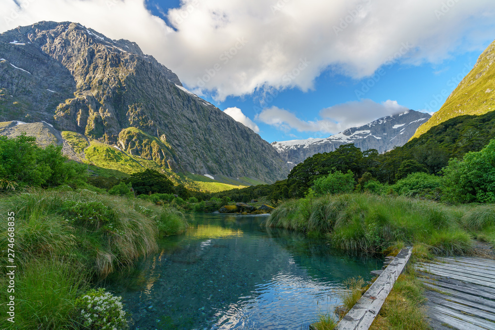 wooden bridge over river in the mountains, fiordland, new zealand 3