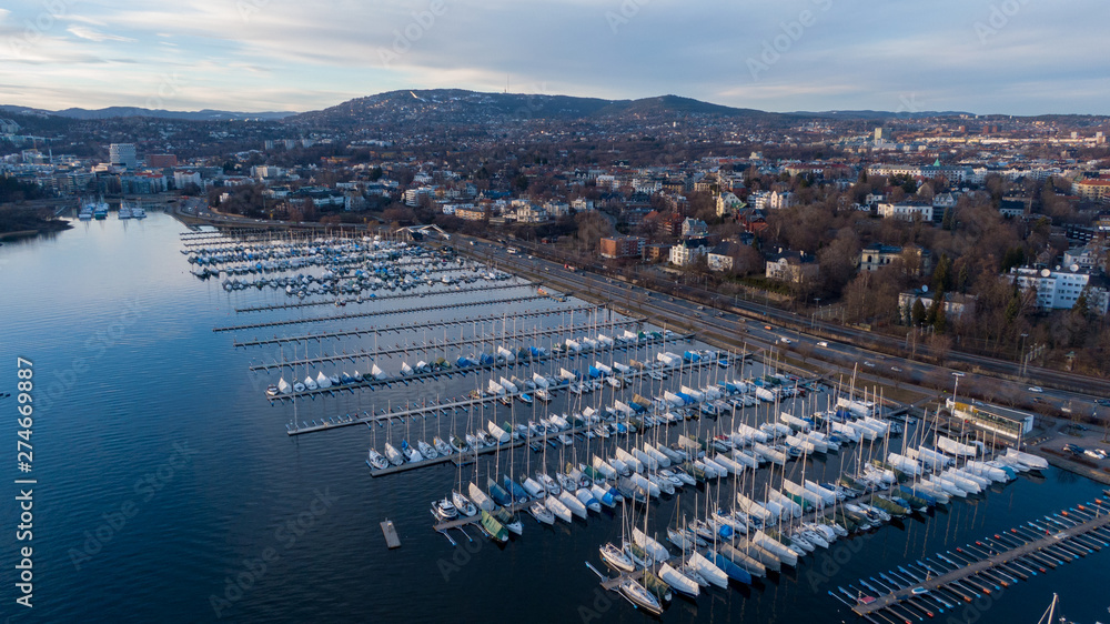 Aerial sunset view on boats in Oslofjord near the e18 highway in Oslo, Norway