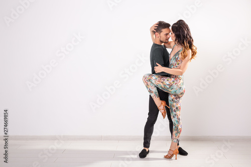 Salsa, kizomba and bachata dancers on white background with copy space. Social dance concept