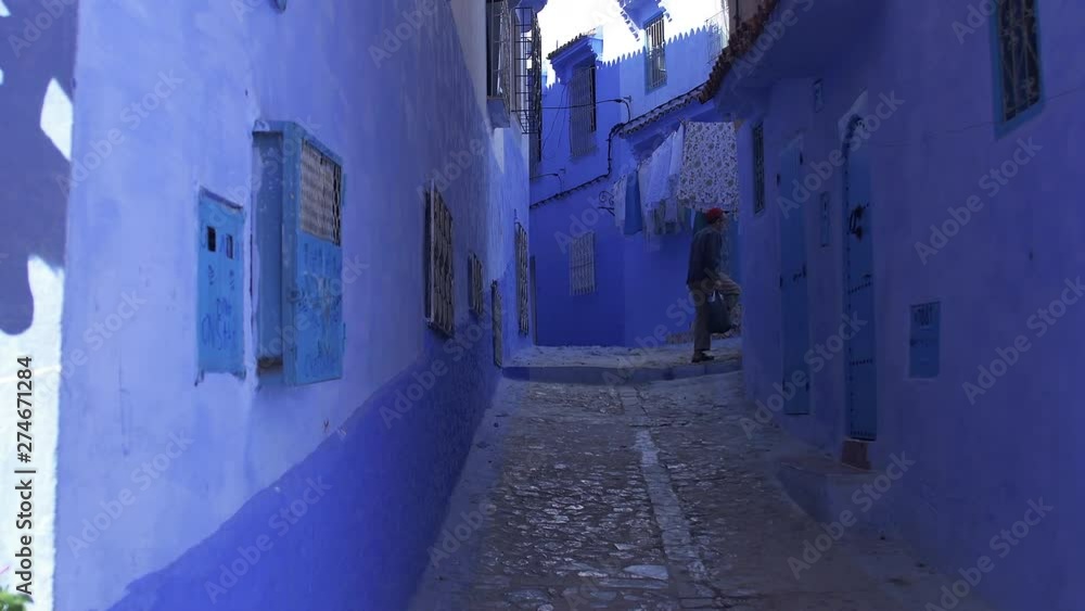 Man walking in the streets of Chefchaouen, Morocco Man walking in the streets of Chefchaouen, Morocco
