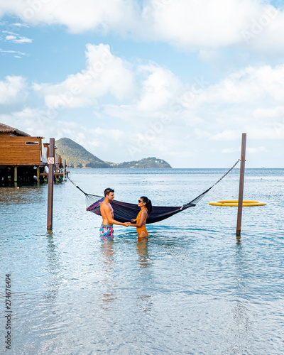 couple on luxury vatation at the tropical Island of Saint Lucia, men and woman by the beach and crystal clear ocean of St Lucia Caribbean Holliday photo