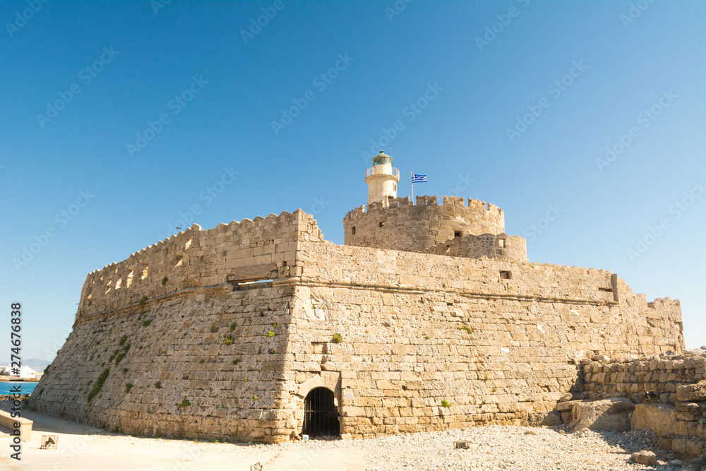 Fort of St. Nicholas with Lighthouse in Mandaki Harbor, Rhodes, Greece Fort of St. Nicholas with Lighthouse in Mandaki Harbor, Rhodes, Greece