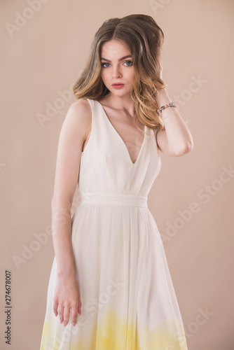 Beautiful woman portrait in elegant dress on beige background © illustrissima