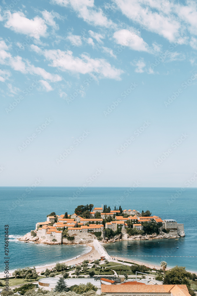 Atmospheric tourist views of the old town from the mountain. The picturesque coast of the island of Sveti Stefan.