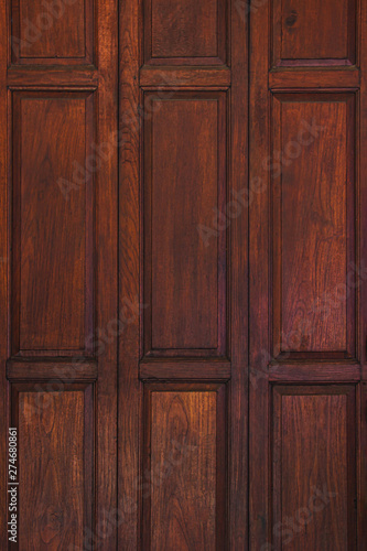 Dark brown old ancient wooden wall background. Thailand traditional style. Using as wallpaper or decorate interior.