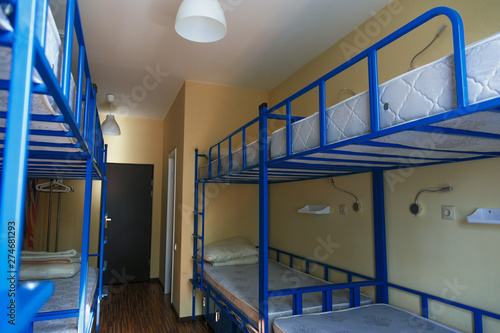 Fotografi Hostel dormitory beds arranged in dorm room