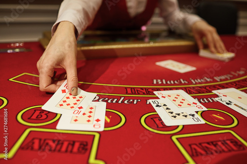 фотографія The croupier in the casino does a shuffle of cards