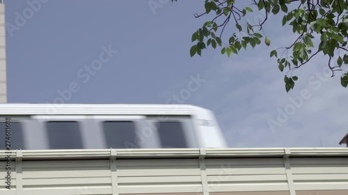Low angle view as a city passenger train passes left to right on an elevated track system.with copy space for text 