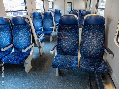 Empty Interior of a Railway Train Commuter Carriage with Blue Seats and White Walls