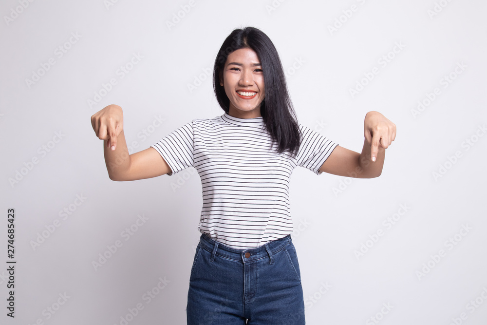 Beautiful young Asian woman point down to blank space. Beautiful young Asian woman point down to blank space.