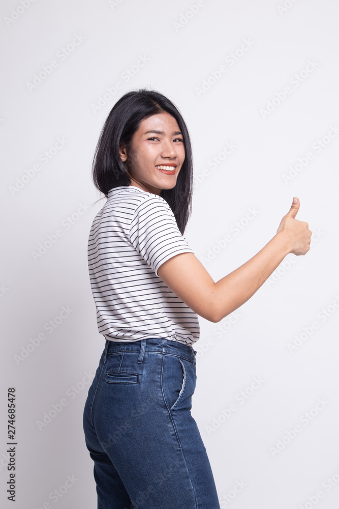 Young Asian woman turn back thumbs up. Young Asian woman turn back thumbs up.