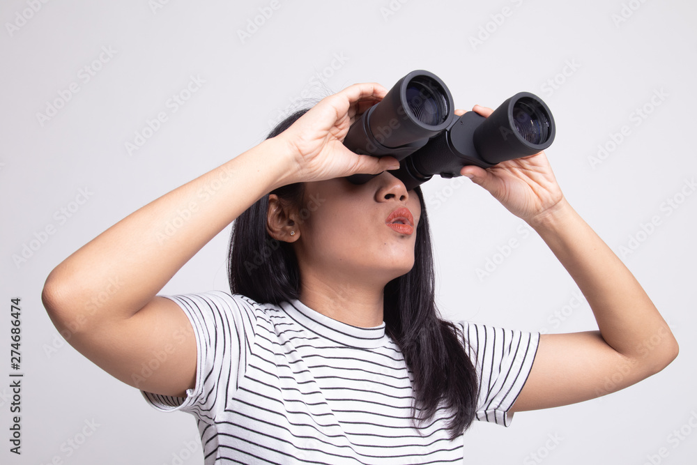 Young Asian woman with binoculars. Young Asian woman with binoculars.