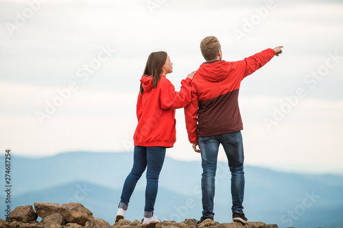 Wallpaper Mural romantic couple in love standing together on a mountain at sunset beach, silhouettes young man and woman on holidays or honeymoon. shop on the mountain Torontodigital.ca