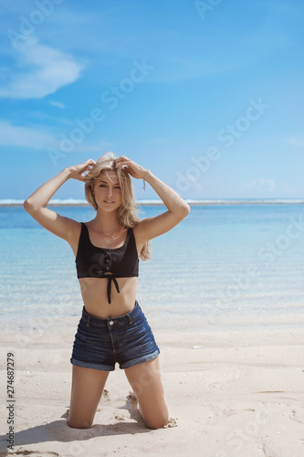 Vertical shot sensual alluring sexy blond tanned woman stand knees posing camera sandy beach touch hair gazing coquettish enjoy vacation, summer tourist travel ocean tropical island enjoy paradise