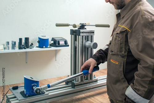 man is testing a torque wrench