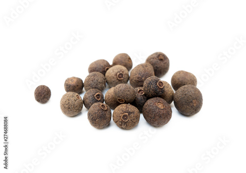 Scattered allspice isolated on white background