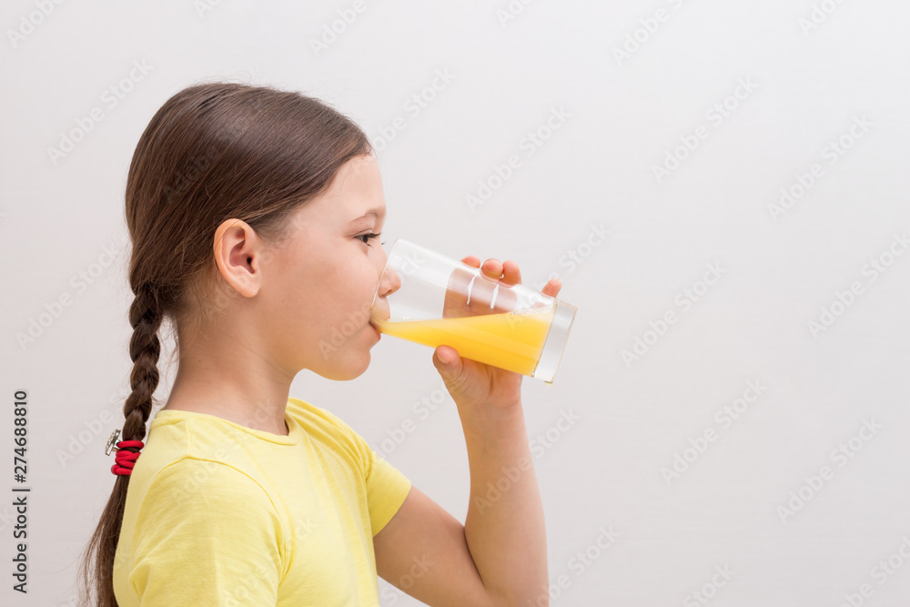 little girl drinks orange juice, a child enjoys a drink little girl drinks orange juice, a child enjoys a drink