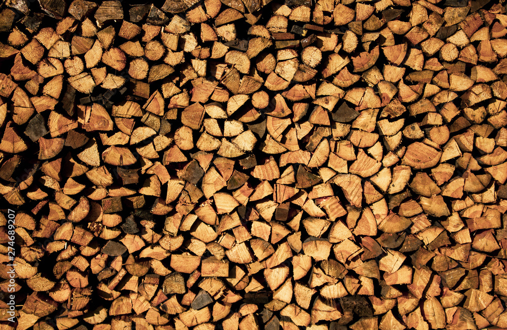 Firewood stacked. Wooden background. Wooden texture. The firewood neatly in the village Firewood stacked. Wooden background. Wooden texture. The firewood neatly in the village