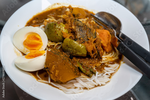 Tai Pla Southern Thai food Curry with Boiled Egg in White Dish