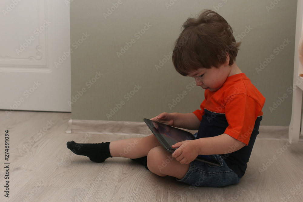 Young kid playing on a floor in a room Young kid playing on a floor in a room