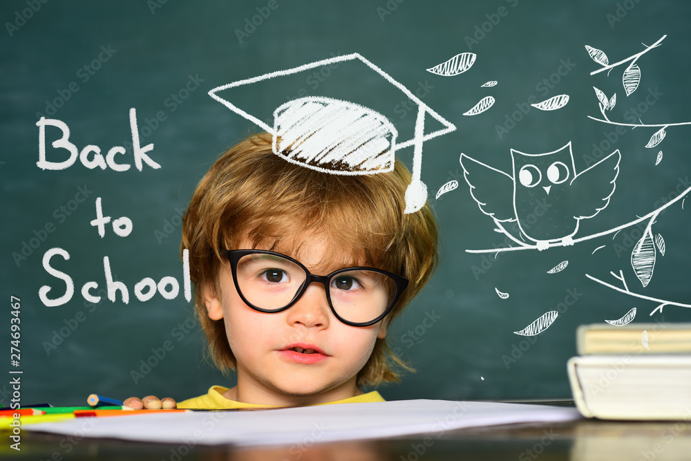 Cute little preschool kid boy in a classroom. Blackboard background.  Teachers day. Kids from primary school. September 1 - Classroom. Stock  Photo | Adobe Stock