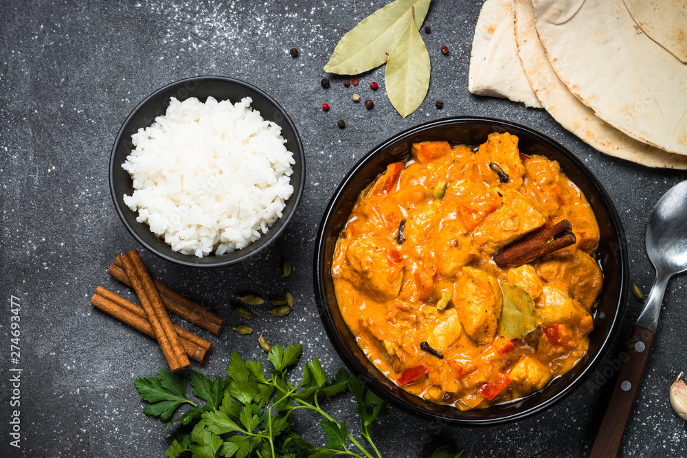 Chicken tikka masala with rice on black top view. Chicken tikka masala with rice on black top view.