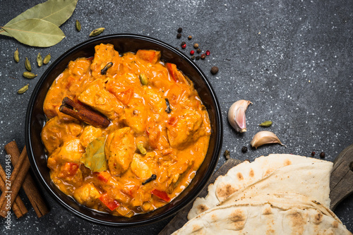 Chicken tikka masala on black top view.